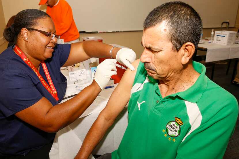 Gerard Rivas of Dallas, receives his flu vaccine during a Binational Health Fair at Mountain...