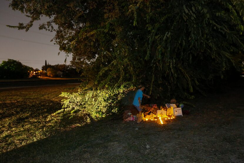 Mikaeel Ali, 7, looks at items left in tribute to Sherin Mathews on Oct. 12. His family left...