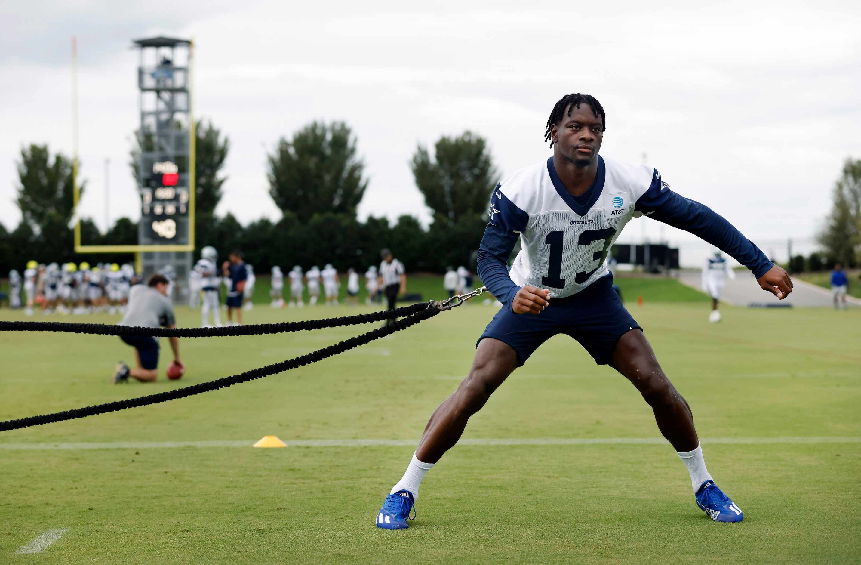 Dallas Cowboys wide receiver Michael Gallup (13) uses a resistance cord to work out during...