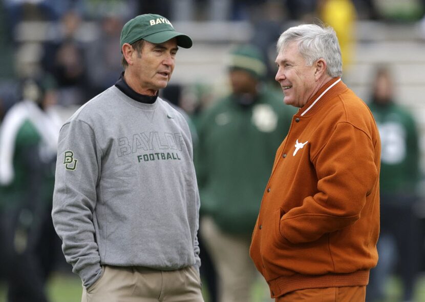 Baylor head coach Art Briles, left, visits with Texas head coach Mack Brown before an NCAA...