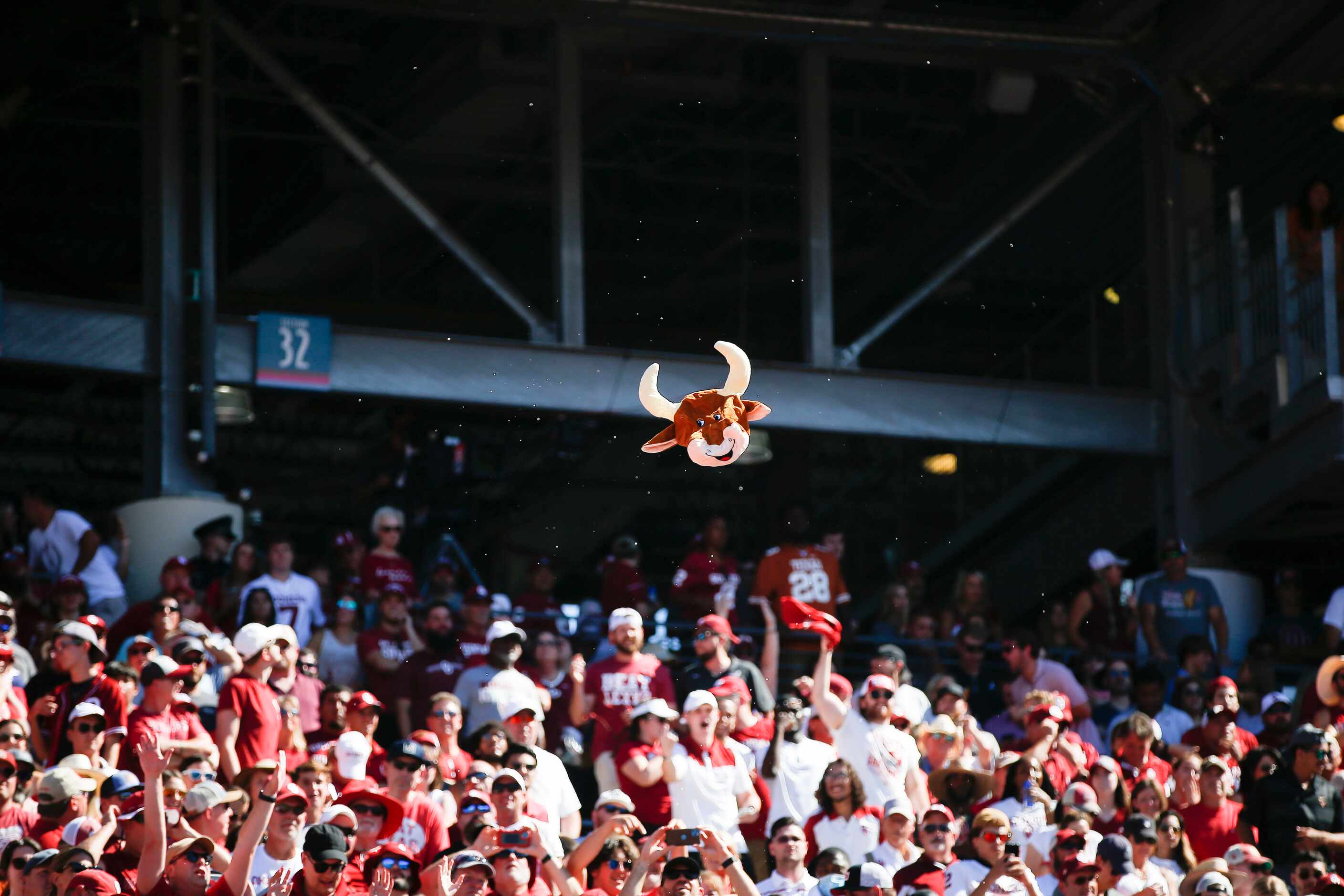 Oklahoma fans toss around the head of a stuffed Bevo doll during the second half of an NCAA...