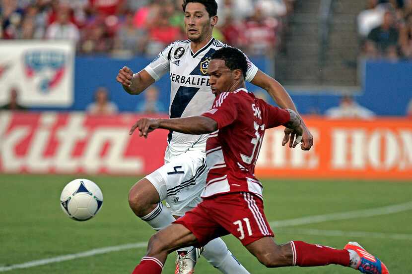 FC Dallas' Scott Sealy (31) launches a shot at the goal as LA Galaxy's Omar Gonzalez (4)...