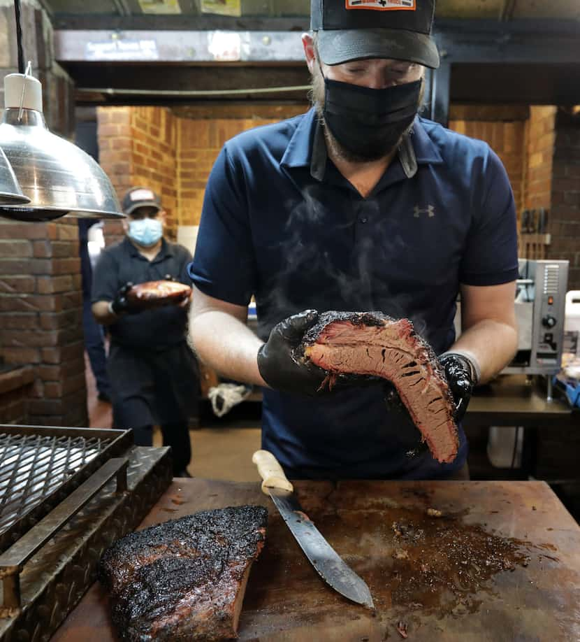 Tim Hutchins cuts some brisket.