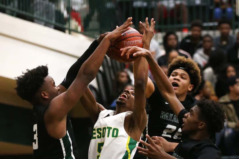 DeSoto's Jarius Hicklen (5) is blocked by the Waxahachie defense in the third quarter at...