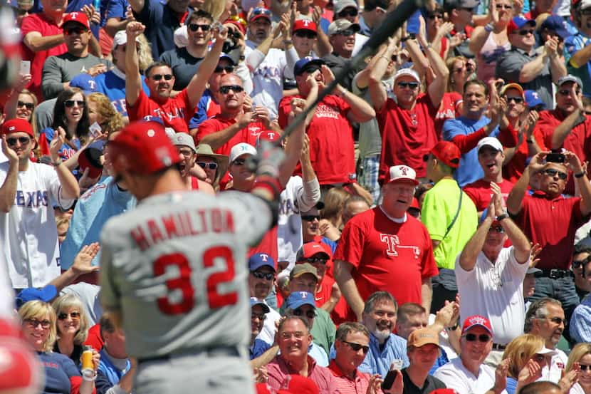 Fans react as Los Angeles' Josh Hamilton strikes out in the second inning during the Texas...