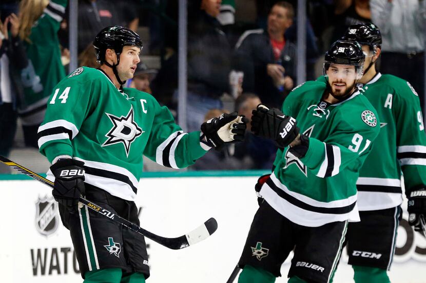 Dallas Stars left wing Jamie Benn (14) is congratulated on his goal by teammate Tyler Seguin...