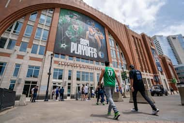 Fans walk into American Airlines Center before Game 4 of an NBA basketball first-round...