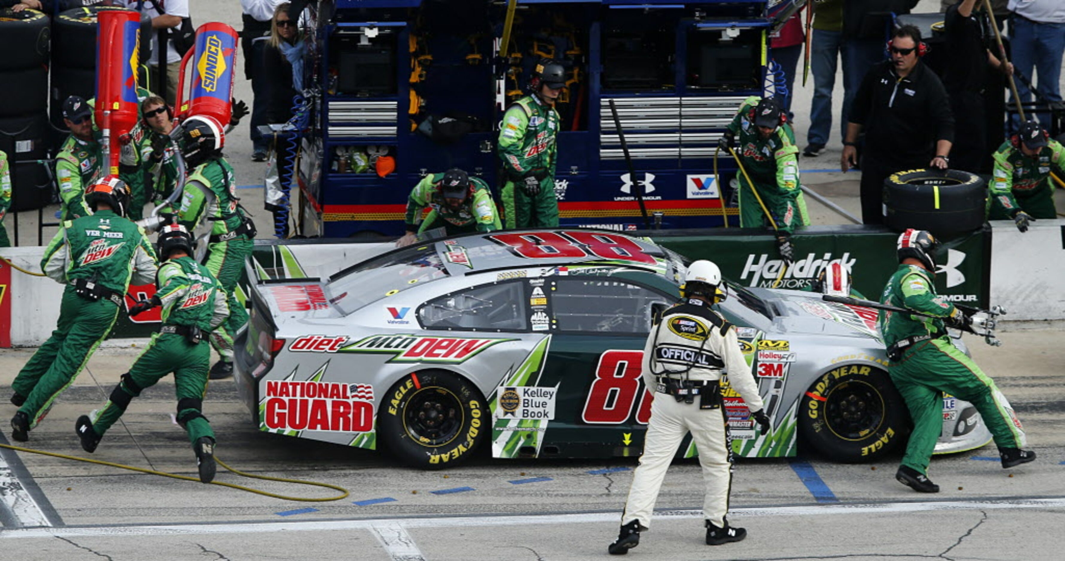 Sprint Cup Series driver Dale Earnhardt Jr. (88) receives a four-tire change during a pit...