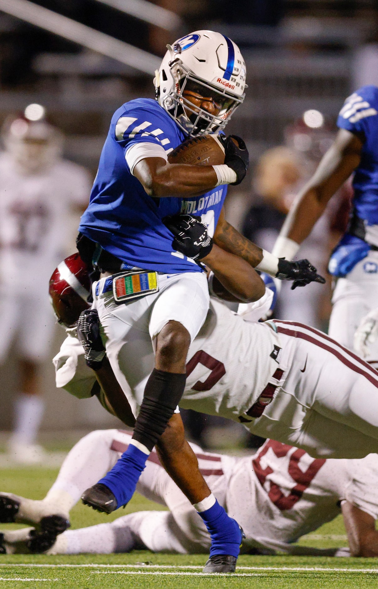 Midlothian running back E.J. Milton (12) slips a tackle from Red Oak defensive end Sevin...