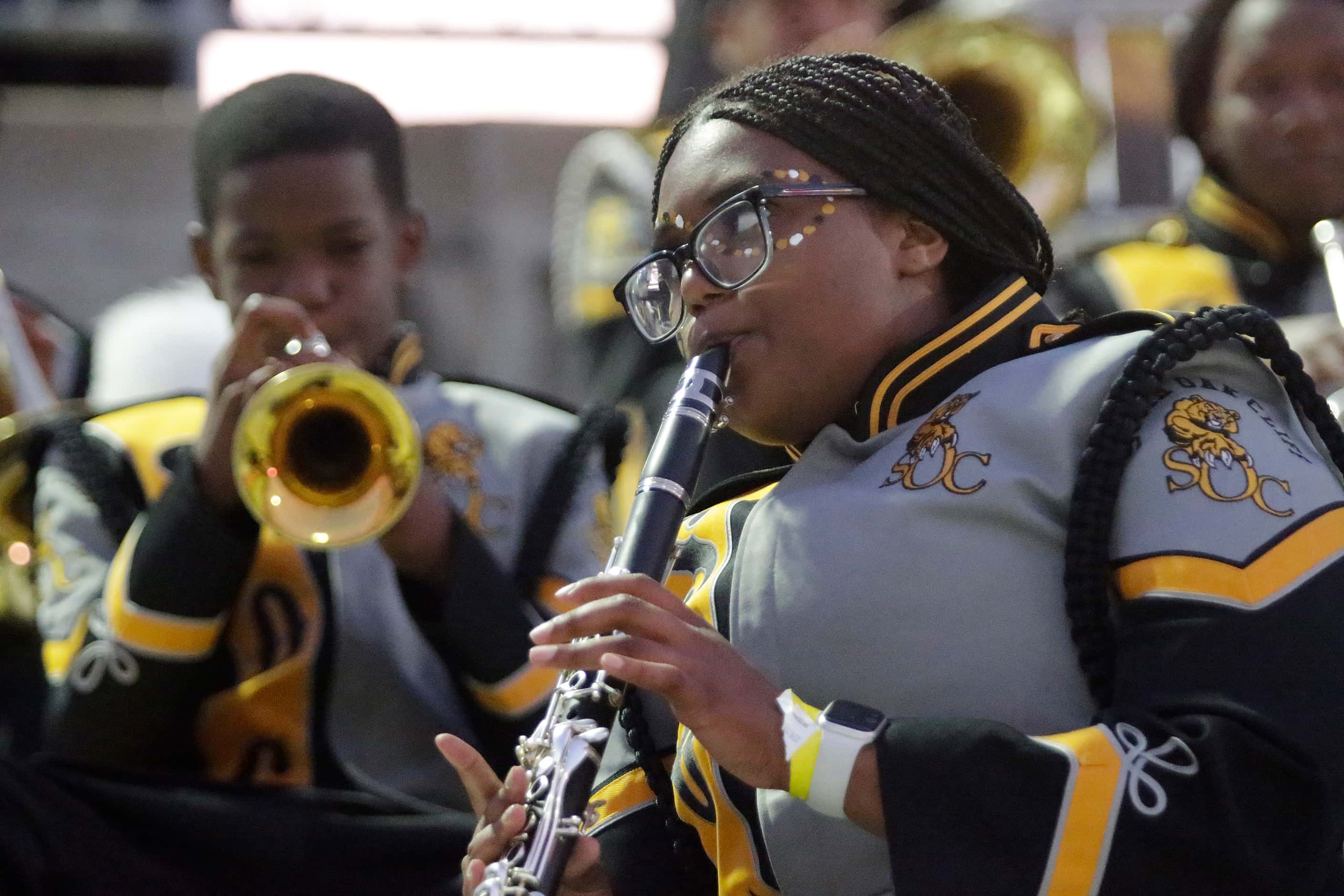 South Oak Cliff Marching Band member Aniyah Slaughter, 15,  warms up on the clarinet before...