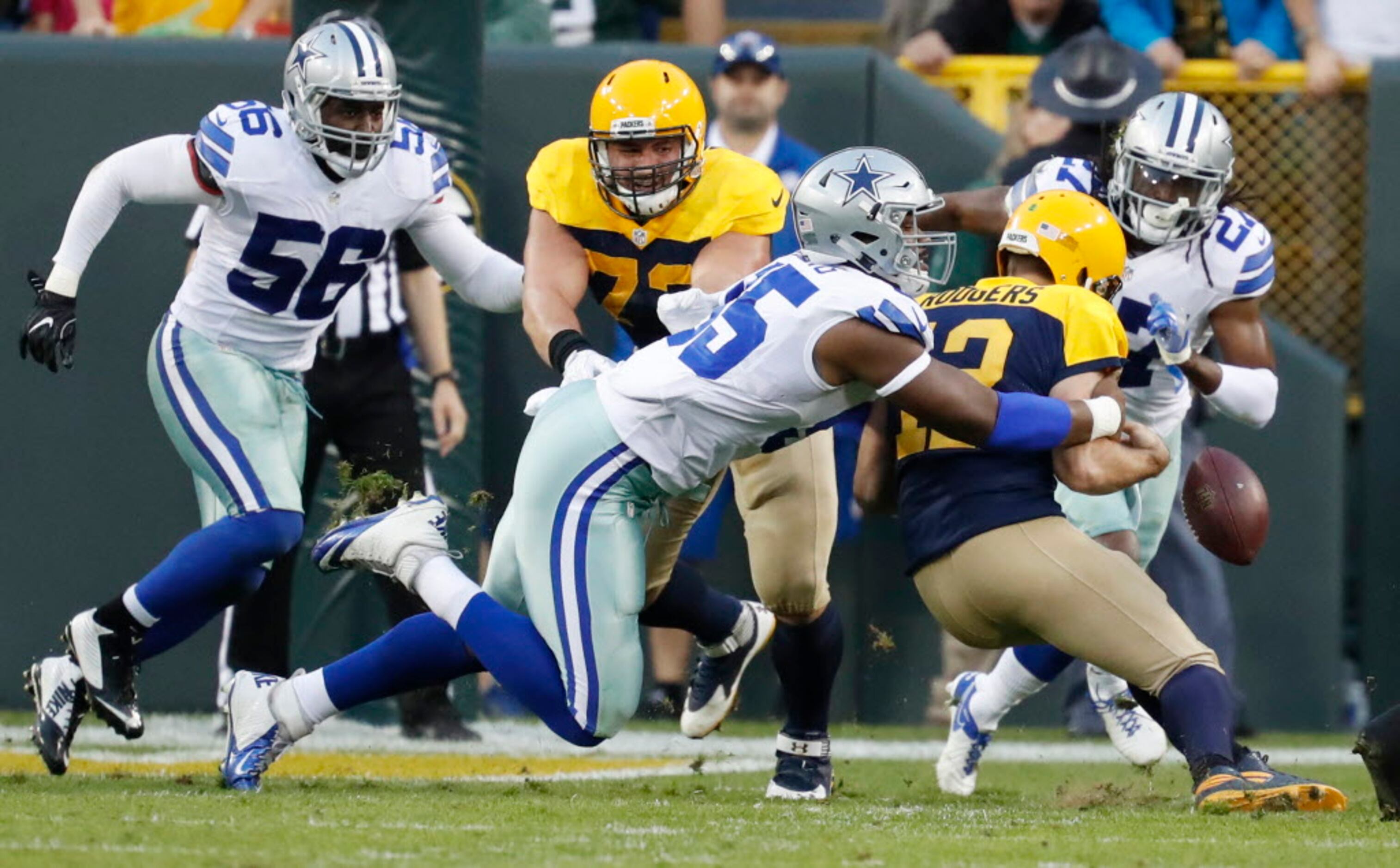 Cowboys roll to 30-16 win, record books in Green Bay