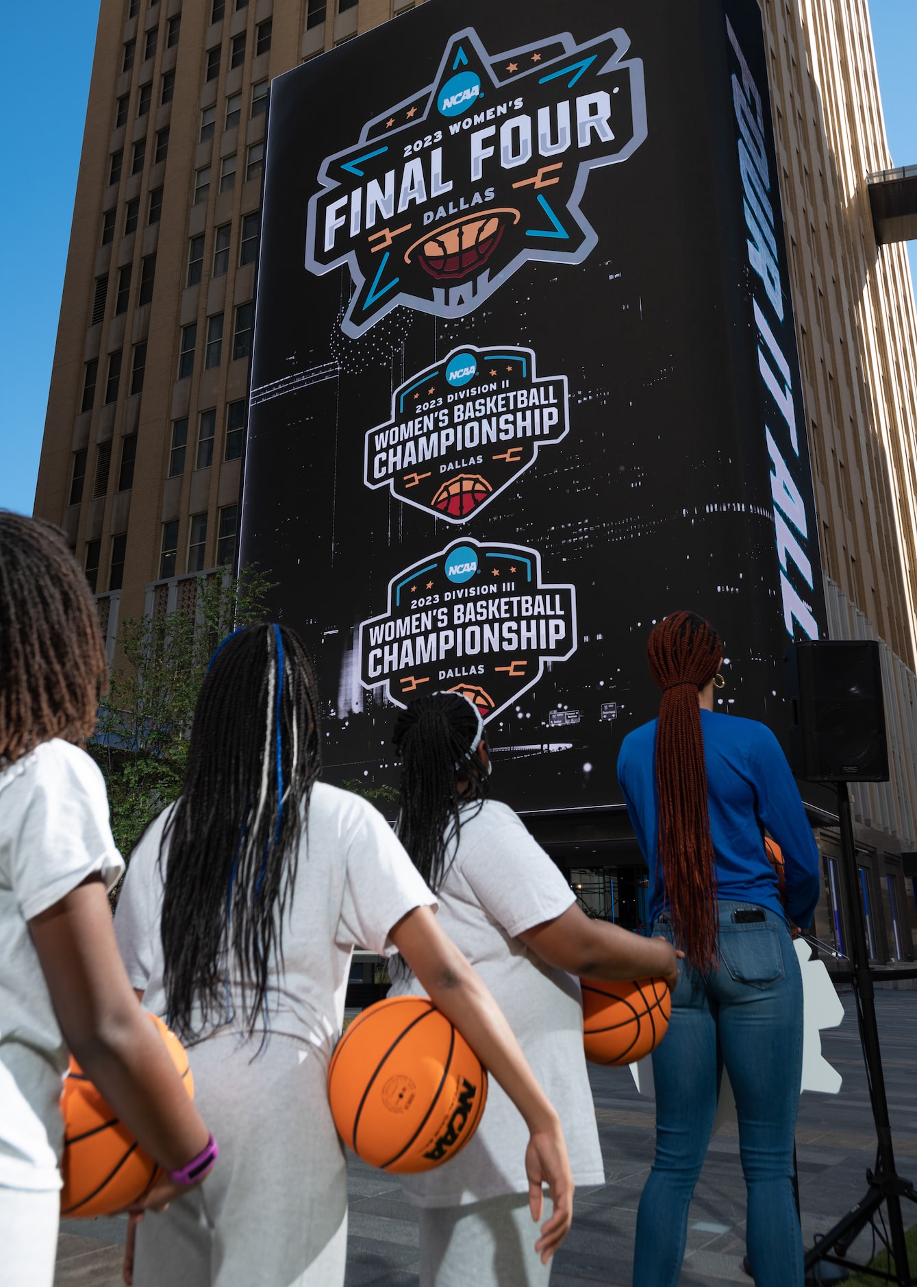 Students from St. Philip's School and Community Center stand alongside Dallas Wings forward...