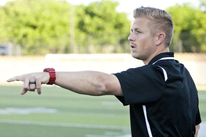 Coppell Coach Chad Rakestraw give directions to his players from the sideline during their...