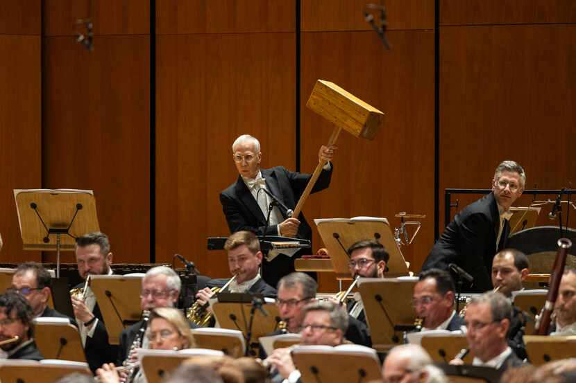Houston Symphony principal percussionist Brian Del Signore wields the giant hammer called...
