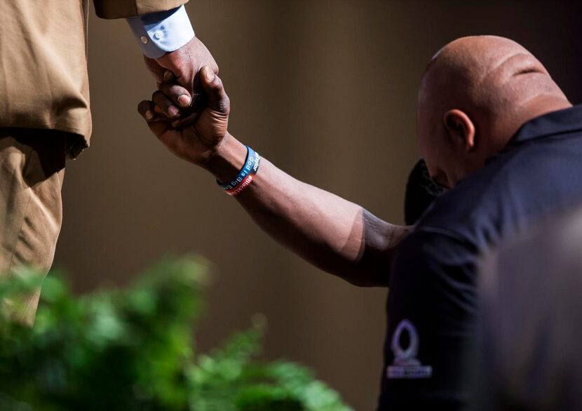 
Adrian Taylor, father of Christian Taylor, prays with Dr. Wm. Dwight McKissic, senior...