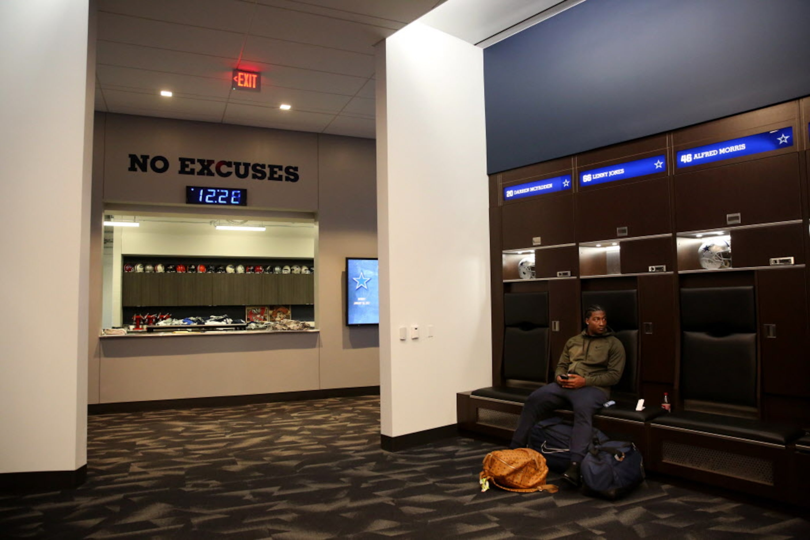 Dallas Cowboys linebacker Lenny Jones sits at his locker after cleaning it out at The Star...