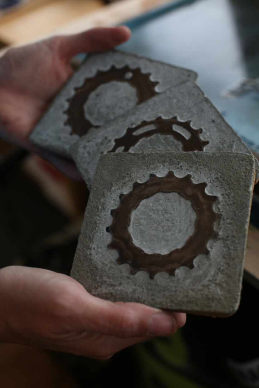 Rachel Spire holds coasters made of bicycle parts at her house in Grapevine October 16, 2012.