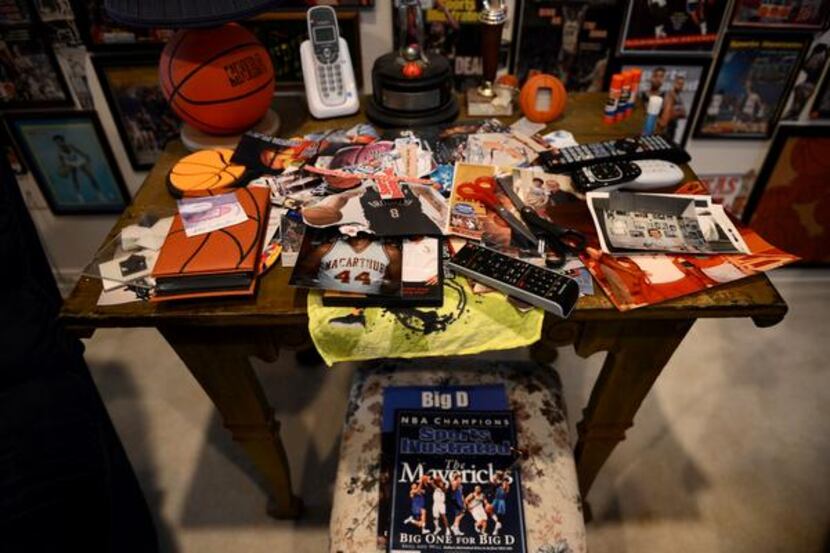 
A table of basketball pictures rests among the other memorabilia he has collected over the...