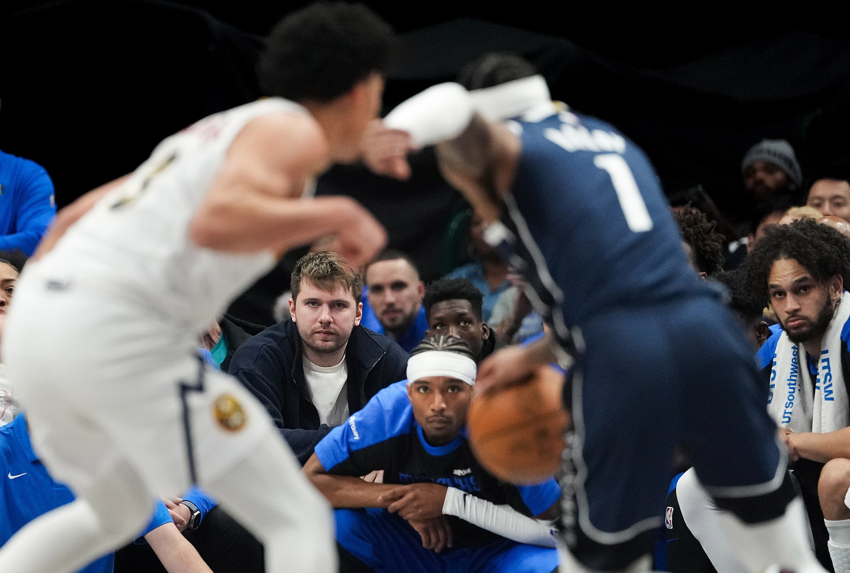 Dallas Mavericks guard Luka Doncic watches from the bench as guard Jaden Hardy (1) works...