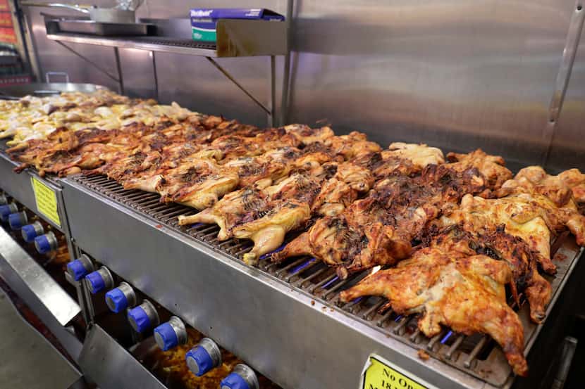 Whole chickens on the grill at the cafe inside the Mi Tienda store in South Houston.