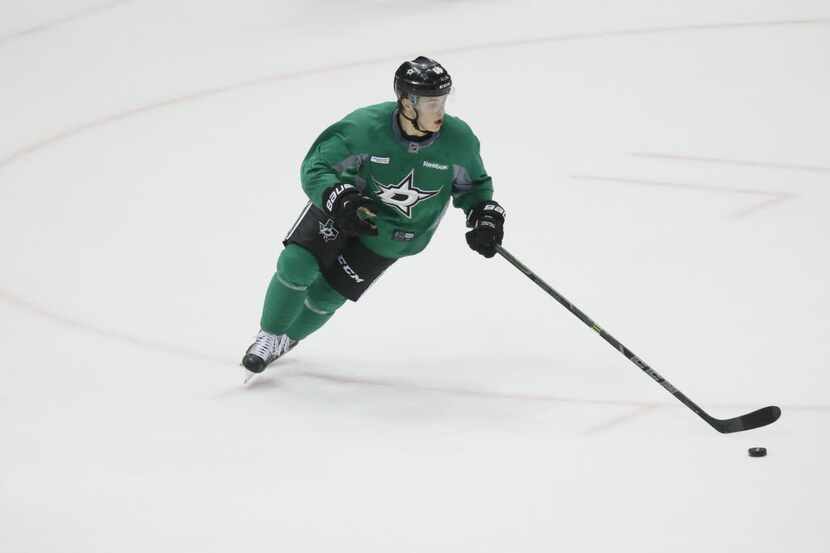 Dallas Stars Julius Honka (#60) controls the puck while he plays in a game during the first...