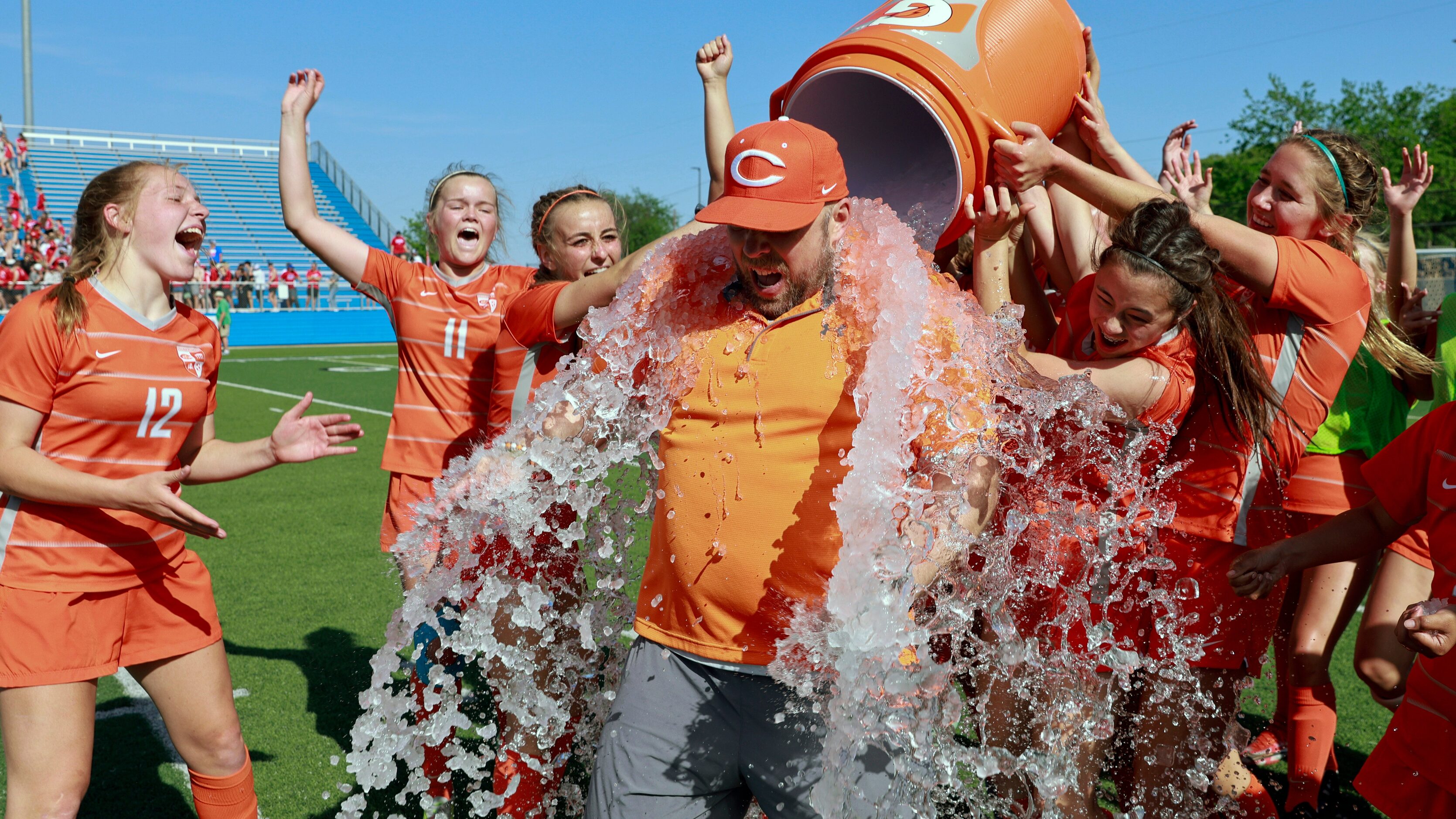 Celina players dump a cooler of water on Celina head coach Alexander Adams after winning the...