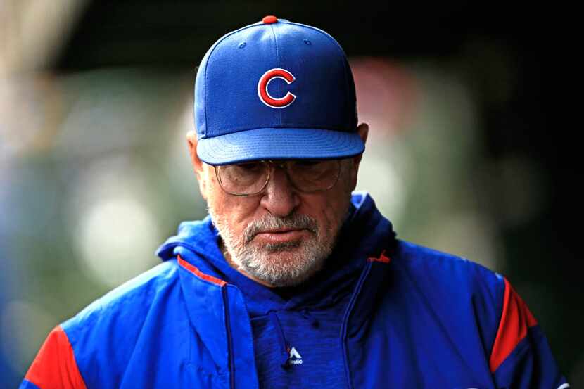CHICAGO, IL - SEPTEMBER 30: Joe Maddon #70 of the Chicago Cubs walks in the dugout against...