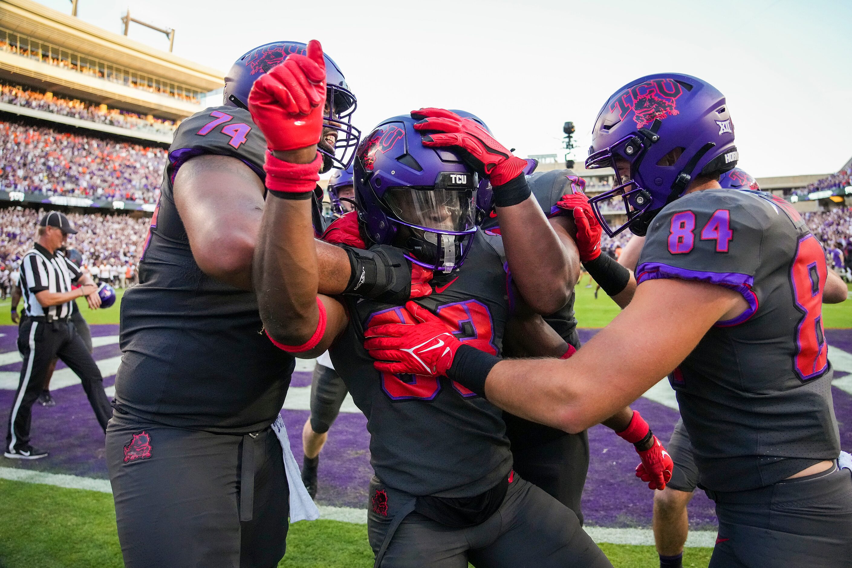 TCU running back Kendre Miller (33) celebrates with offensive tackle Brandon Coleman (77)...