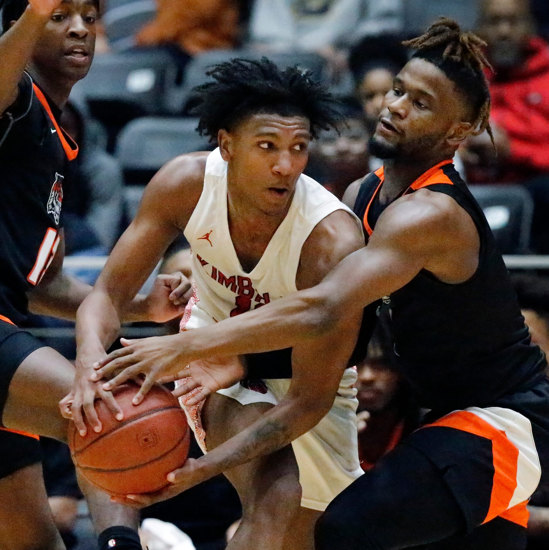 Kimball High School forward Cory Reynolds (11) looks to pass as Lancaster High School guard...