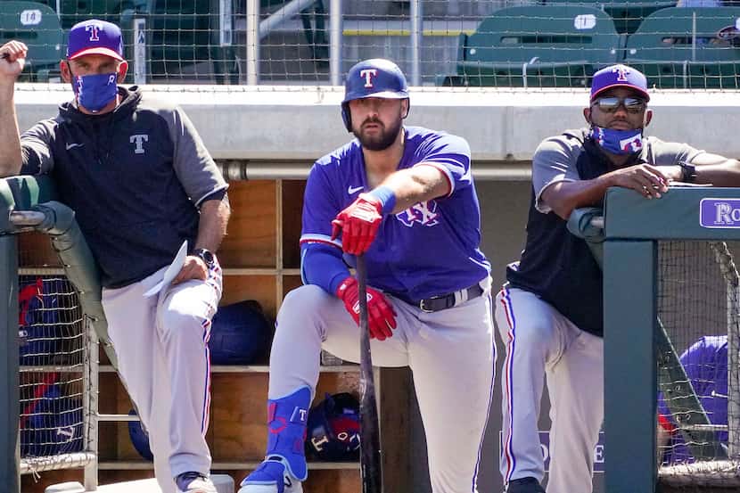 Texas Rangers manager Chris Woodward (left), outfielder Joey Gallo (center) and assistant...