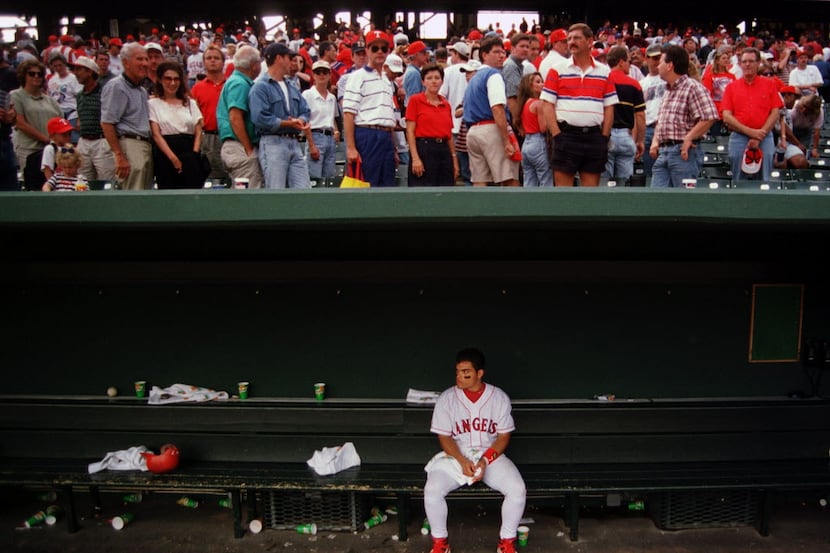 10/5/96---Rangers catcher Ivan Rodriguez sits all alone after his teammates left the dugout...