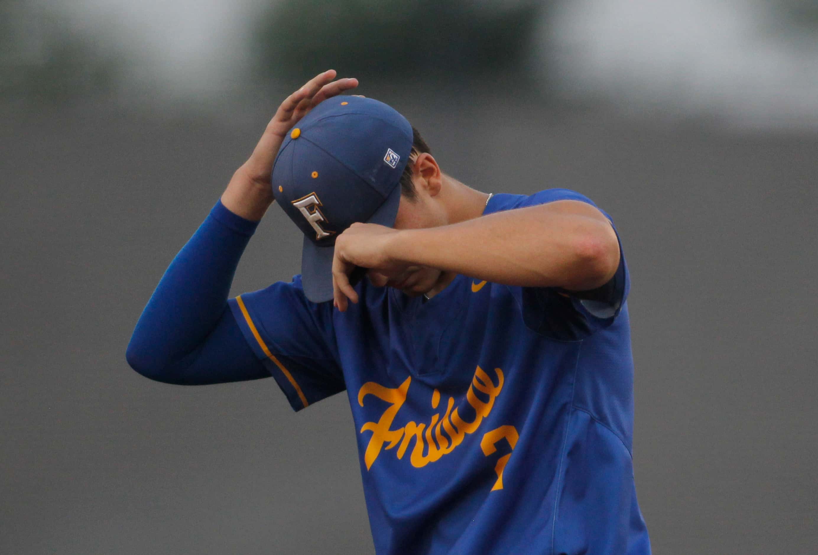 Frisco pitcher Michael Catalano (2) adjusts his ball cap between batters during the bottom...