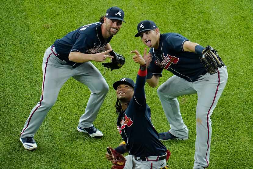 Atlanta Braves center fielder Ronald Acuna Jr. (center) pretends to take a selfie with right...
