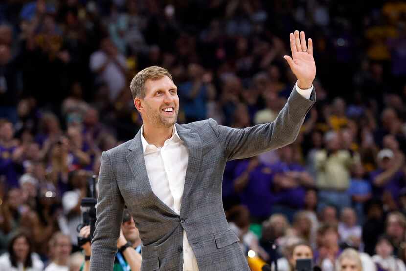Former Dallas Mavericks forward Dirk Nowitzki waves to the crowd after being introduced as...