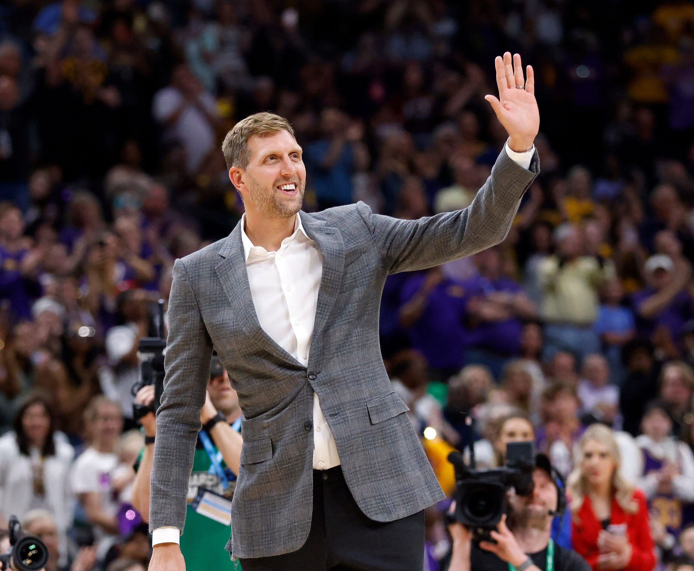 Former Dallas Mavericks forward Dirk Nowitzki waves to the crowd after being introduced as...