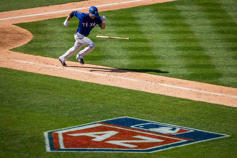 Texas Rangers infielder Darwin Barney heads for first on a grounder during the sixth inning...
