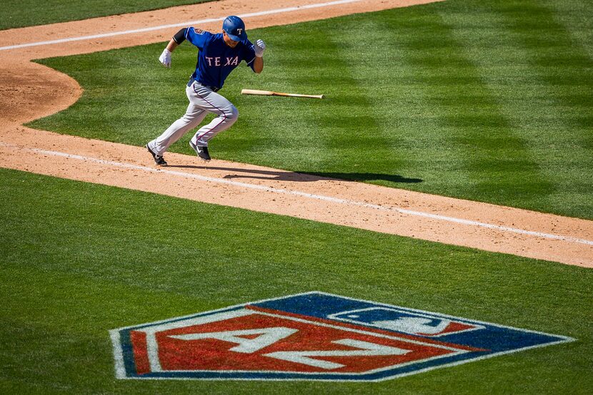 Texas Rangers infielder Darwin Barney heads for first on a grounder during the sixth inning...