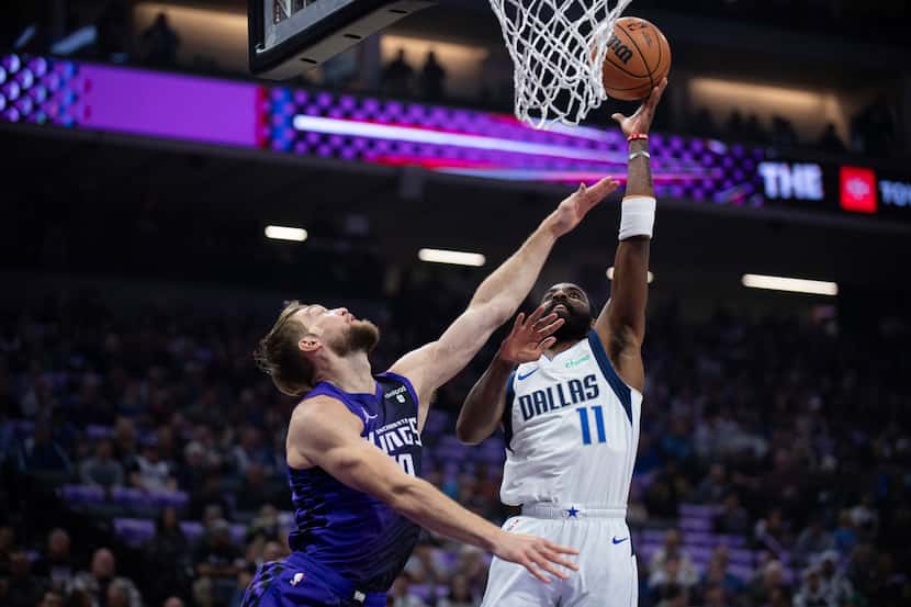 Dallas Mavericks guard Kyrie Irving (11) shoots over Sacramento Kings forward Domantas...