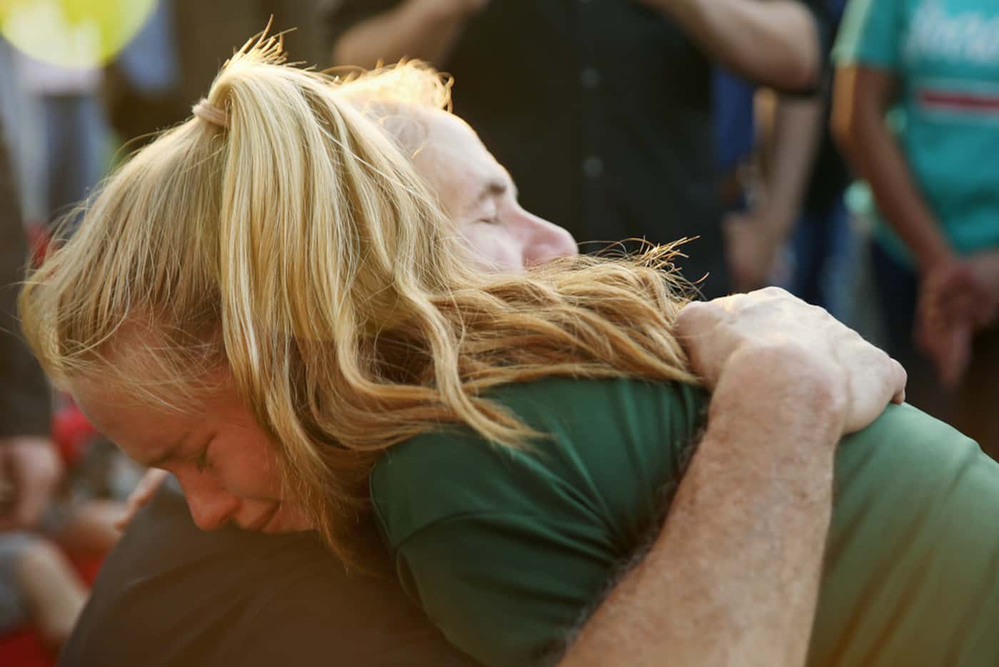 Gov. Greg Abbott hugs Santa Fe High School student Rylie Bouvier, 15, during a vigil after a...