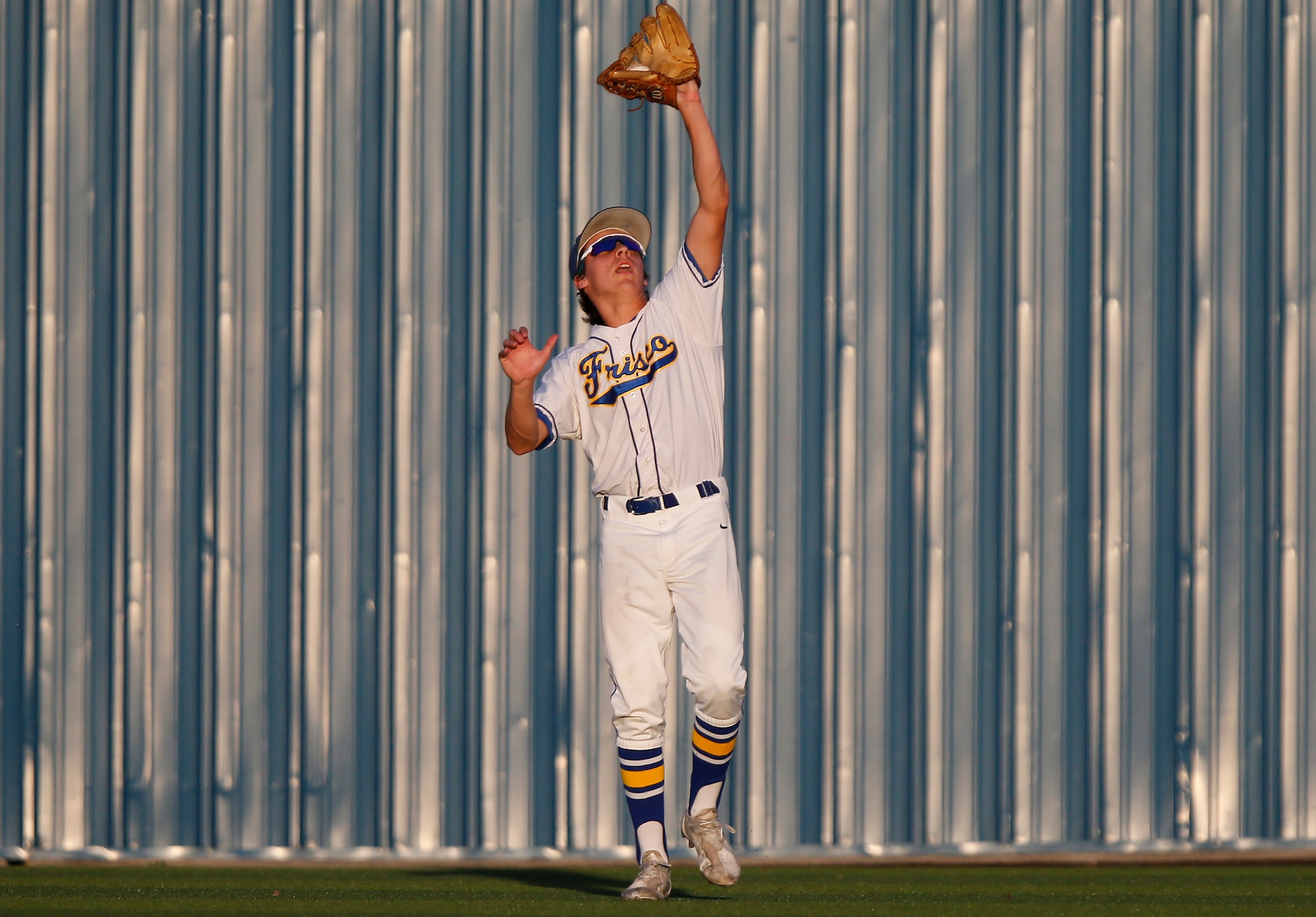 Frisco center fielder Jimmy Catalano (9) catches pop fly for an out in the second inning as...