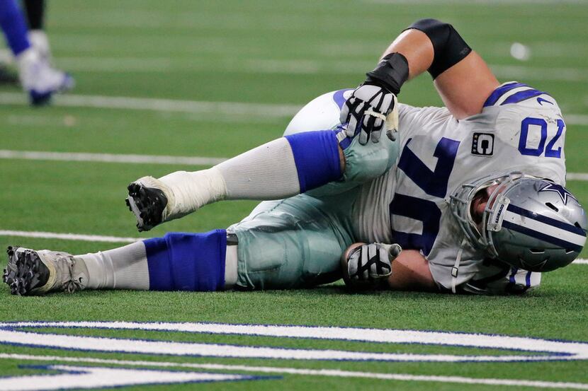 Dallas Cowboys offensive guard Zack Martin (70) hits the turf after getting hurt in the...
