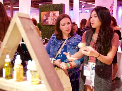 "Honey Belle" Sales Rep Victoria Lee, right, shows Claire Huntsman the companies various...