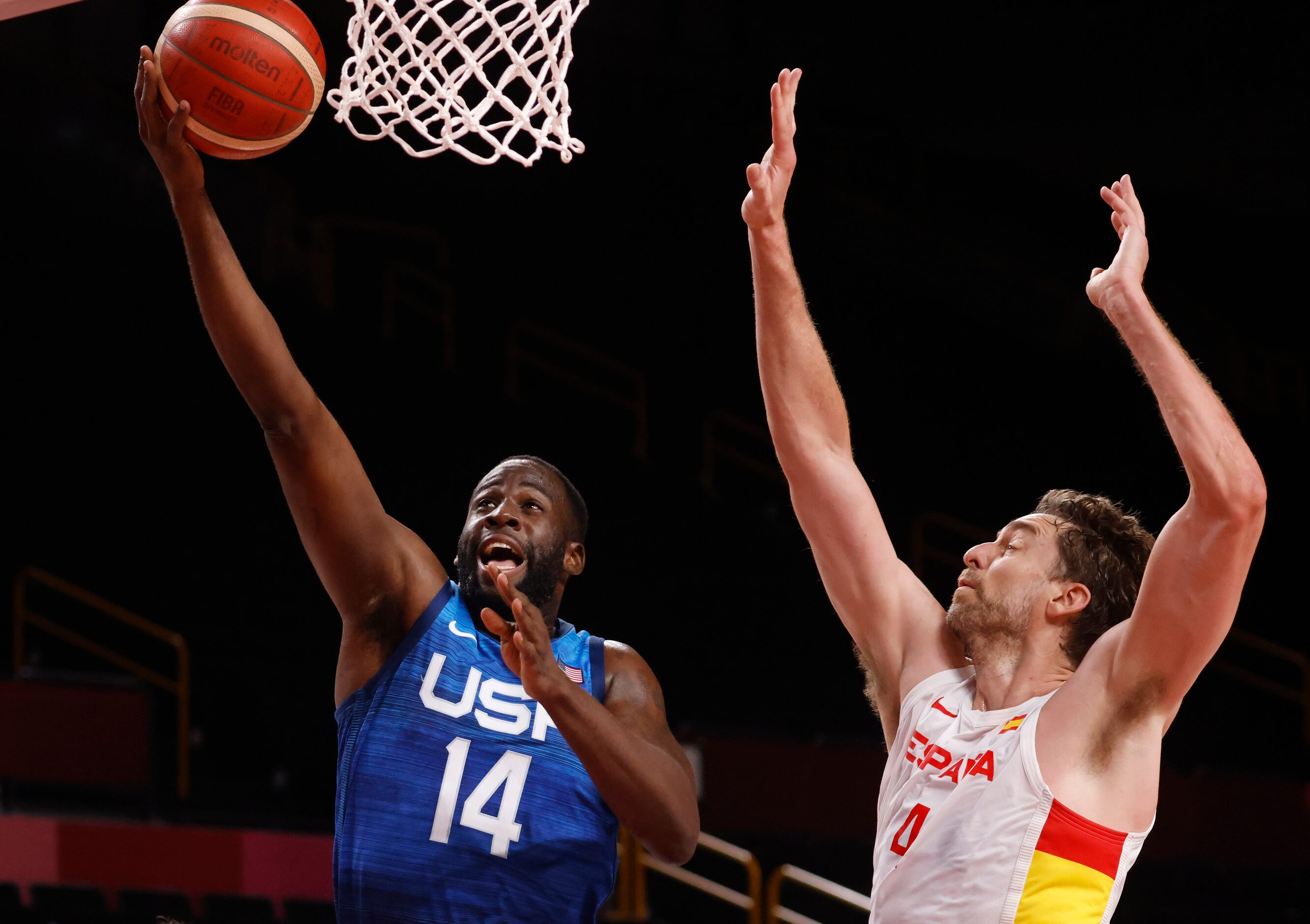 USA’s Draymond Green (14) attempts a shot in front of Spain’s Pau Gasol (4) during the first...