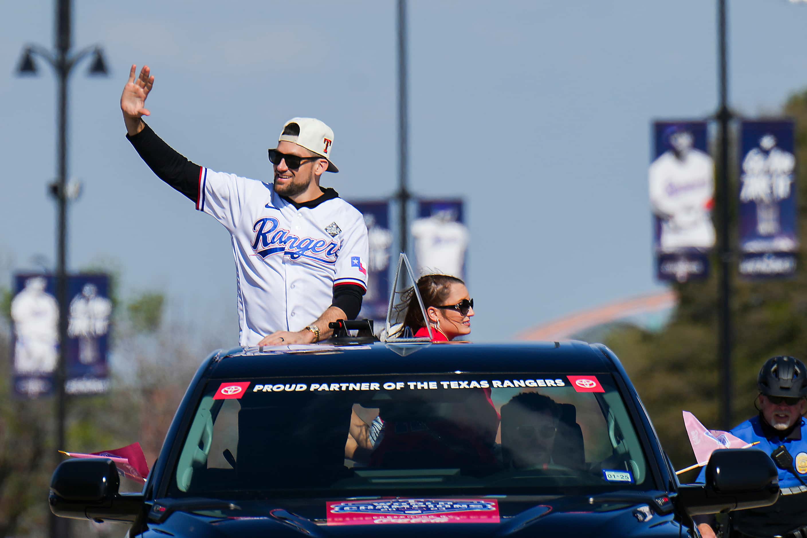 Starting pitcher Nathan Eovaldi waves to fans from the back of a truck during the Texas...