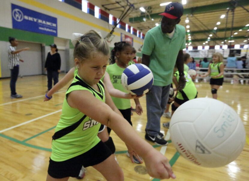 Zoe Smith of the Lil' Smash team worked on her serve before Saturday's volleyball tournament...