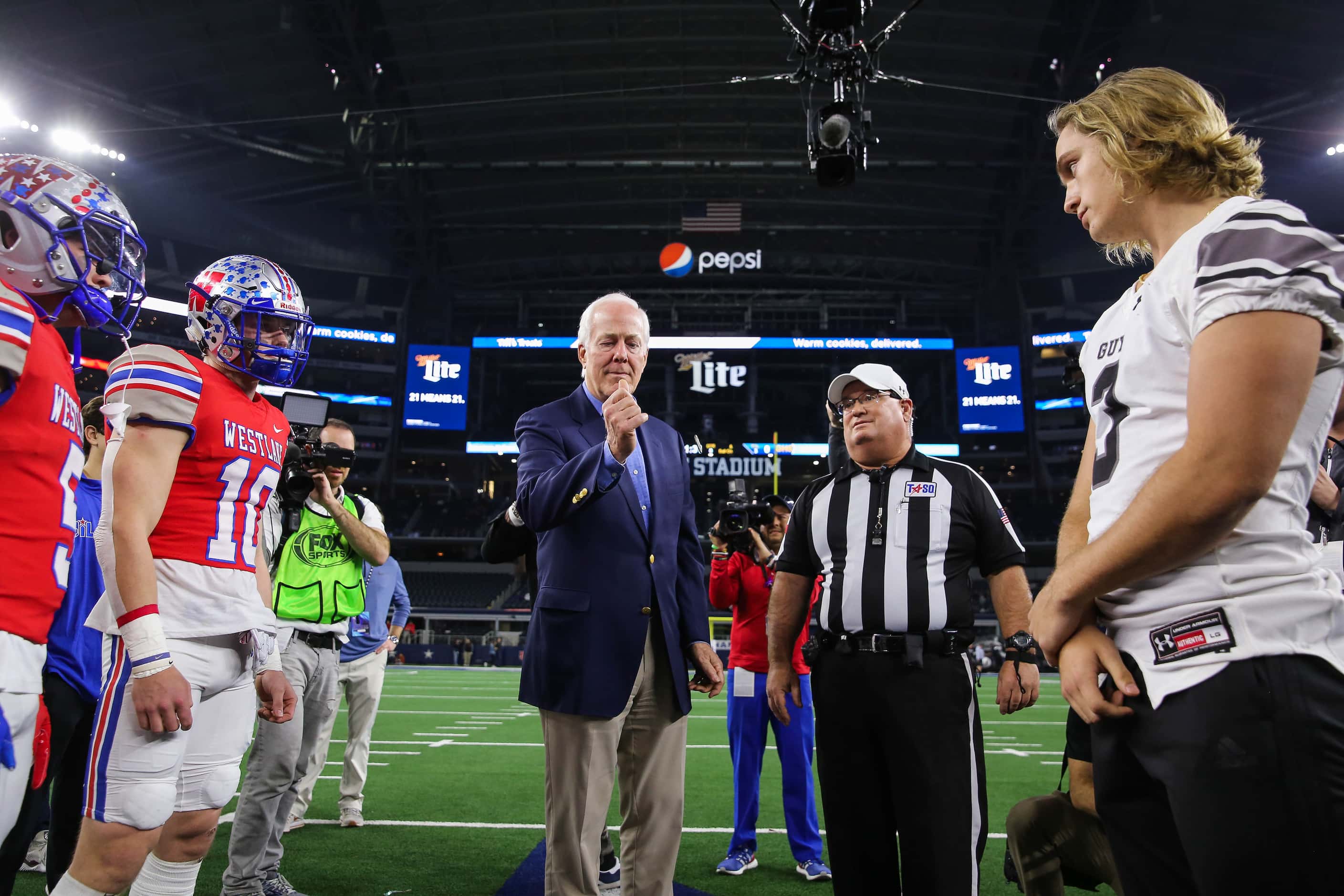 U.S. Sen. John Cornyn officiates the coin toss of a Class 6A Division II state championship...
