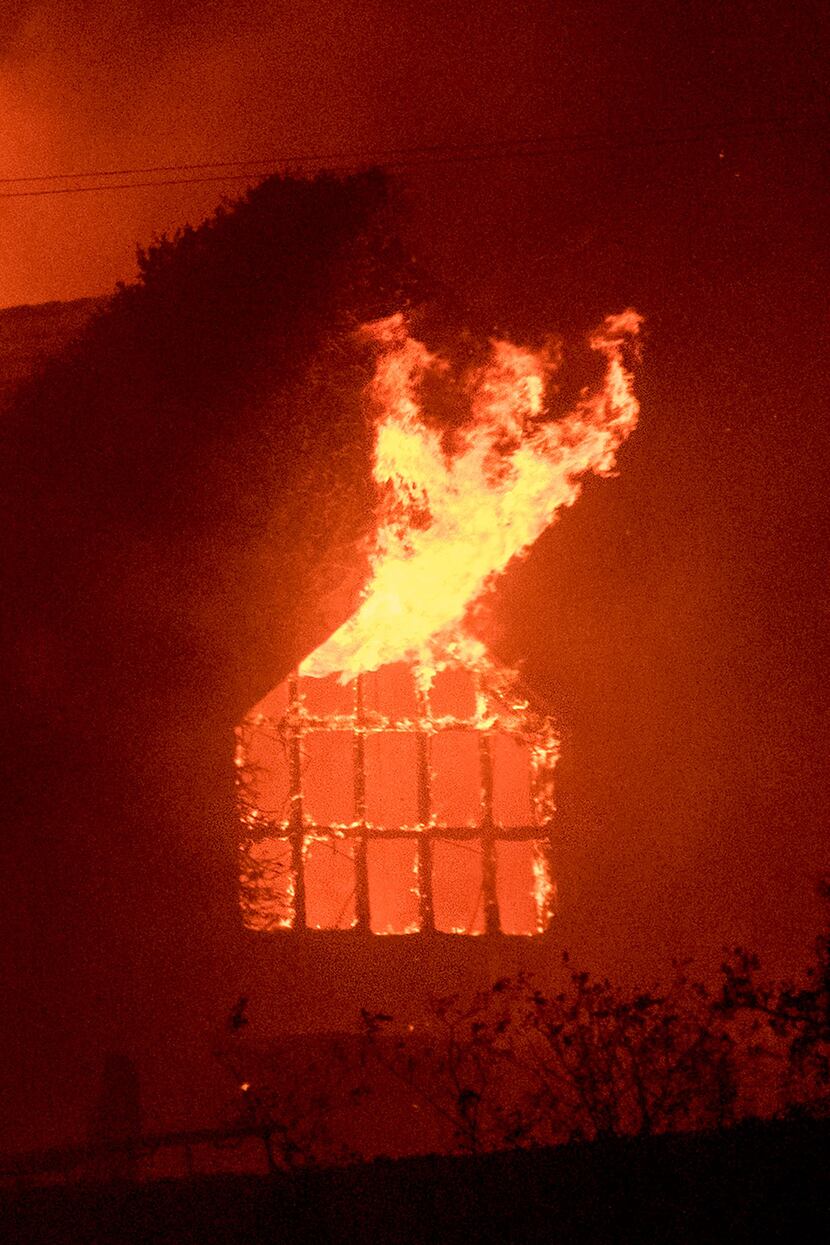 Flames shoot out from a window as the Signorello Estate winery burns in the Napa wine region...