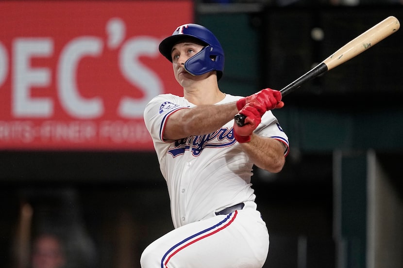 Texas Rangers' Wyatt Langford follows through on a run-scoring double in the third inning of...