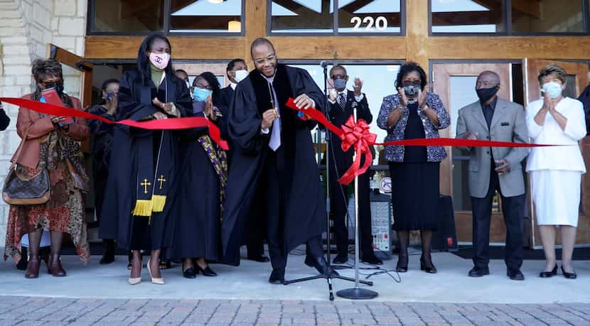 Pastor Bryant Phelps, alongside church and lay leaders, cut the red-velvet ribbon Sunday...
