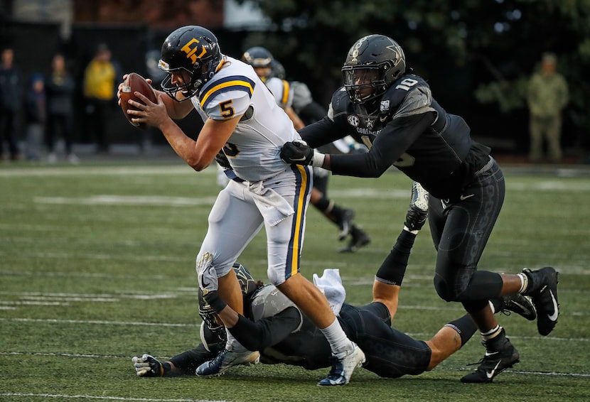 Trey Mitchell #5 of the East Tennessee State Buccaneers is sacked by defensive lineman Dayo...